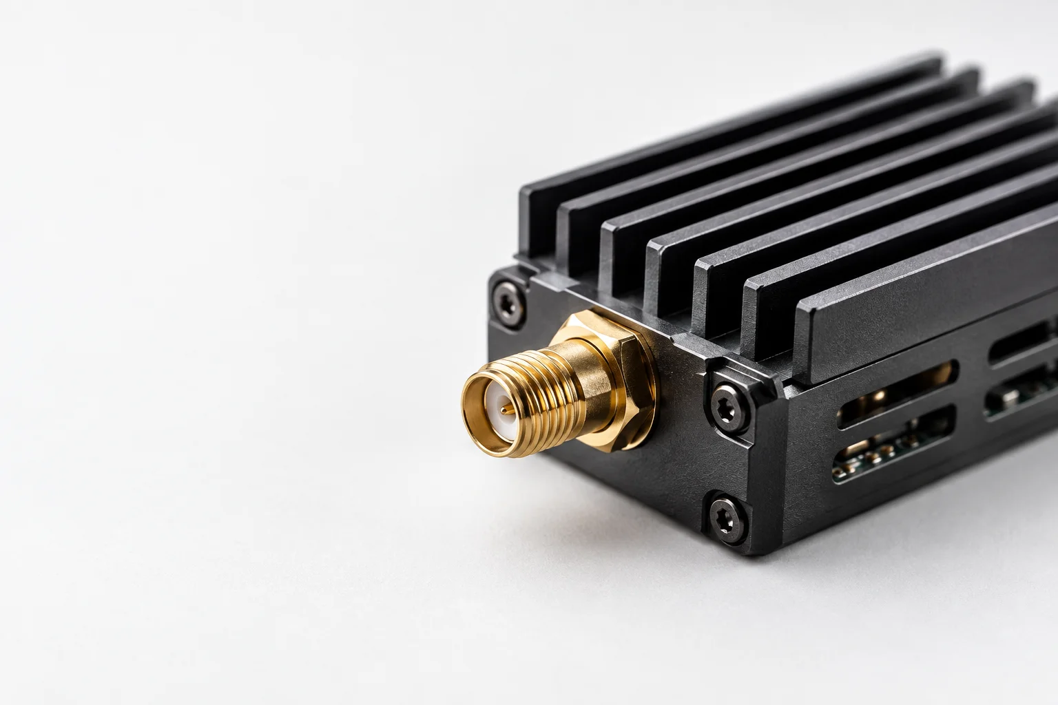 Illustrative close-up of transmitter cooling fins and an antenna connector